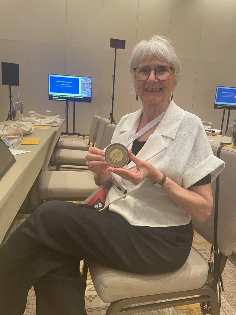Maureen with a medal for her work at EDF